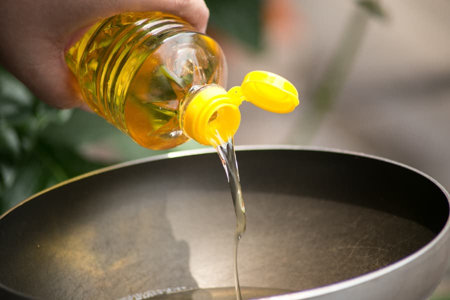 Cooking oil being poured into pan